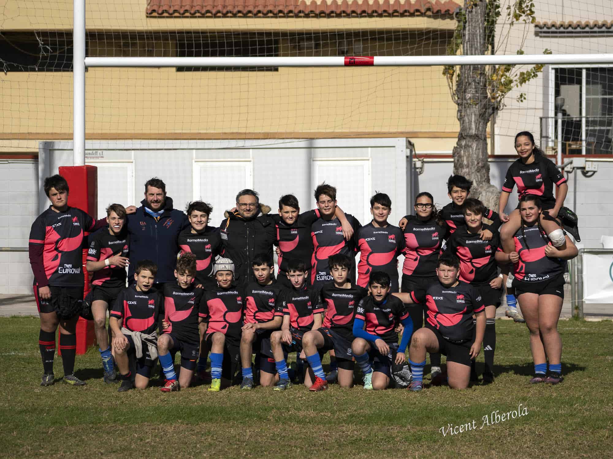 quipo de rugby base posando en grupo junto a sus entrenadores